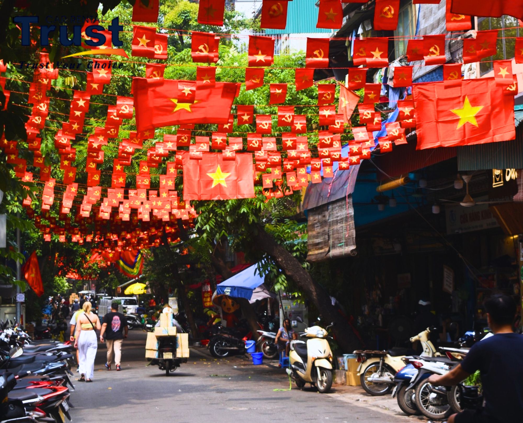 a-bustling-street-in-hanois-old-quarter-showcasing-traditional-shops-motorbikes-and-a-colorful-display-of-red-flags
