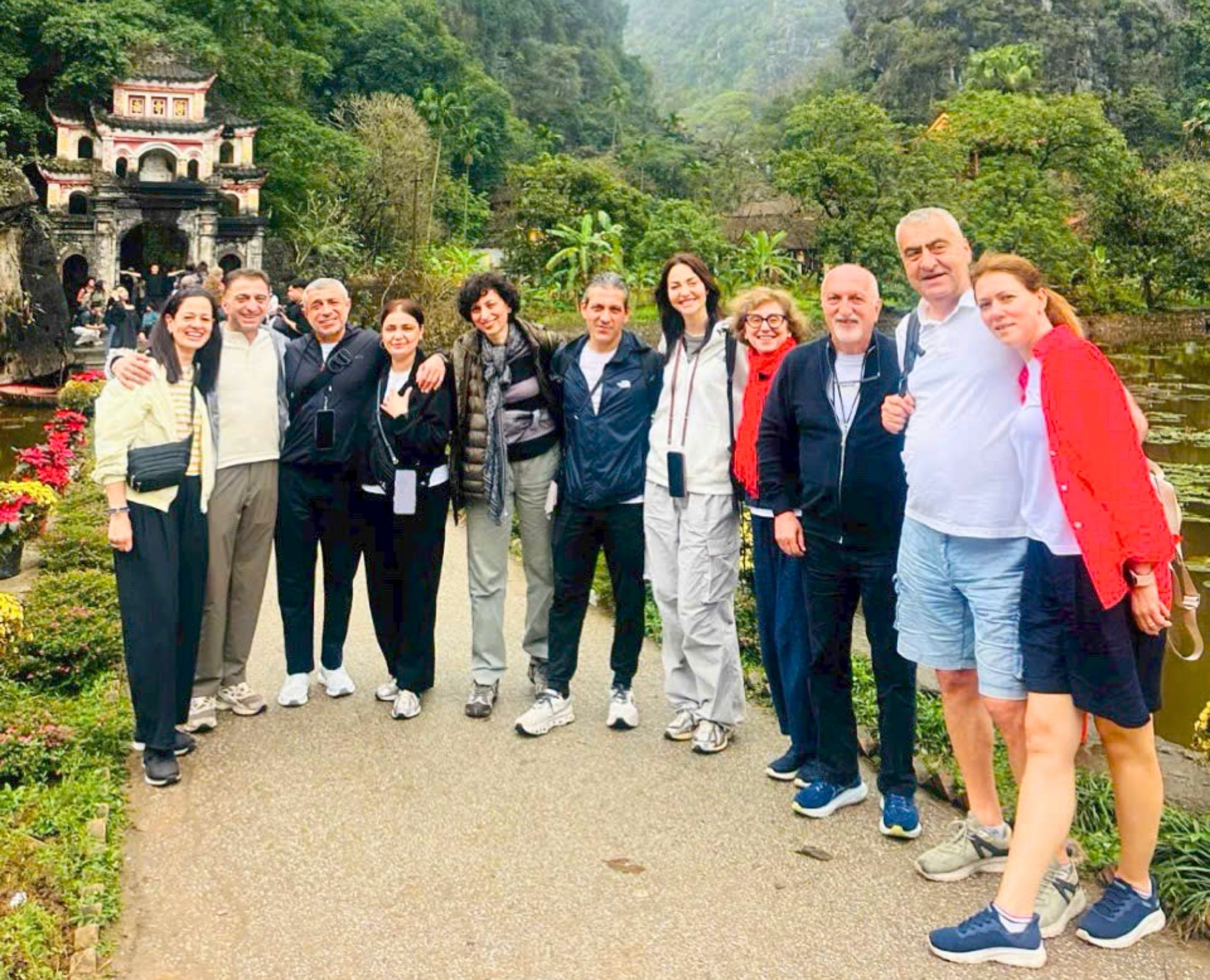 A group of international tourists visiting the ancient Bich Dong Pagoda in Ninh Binh