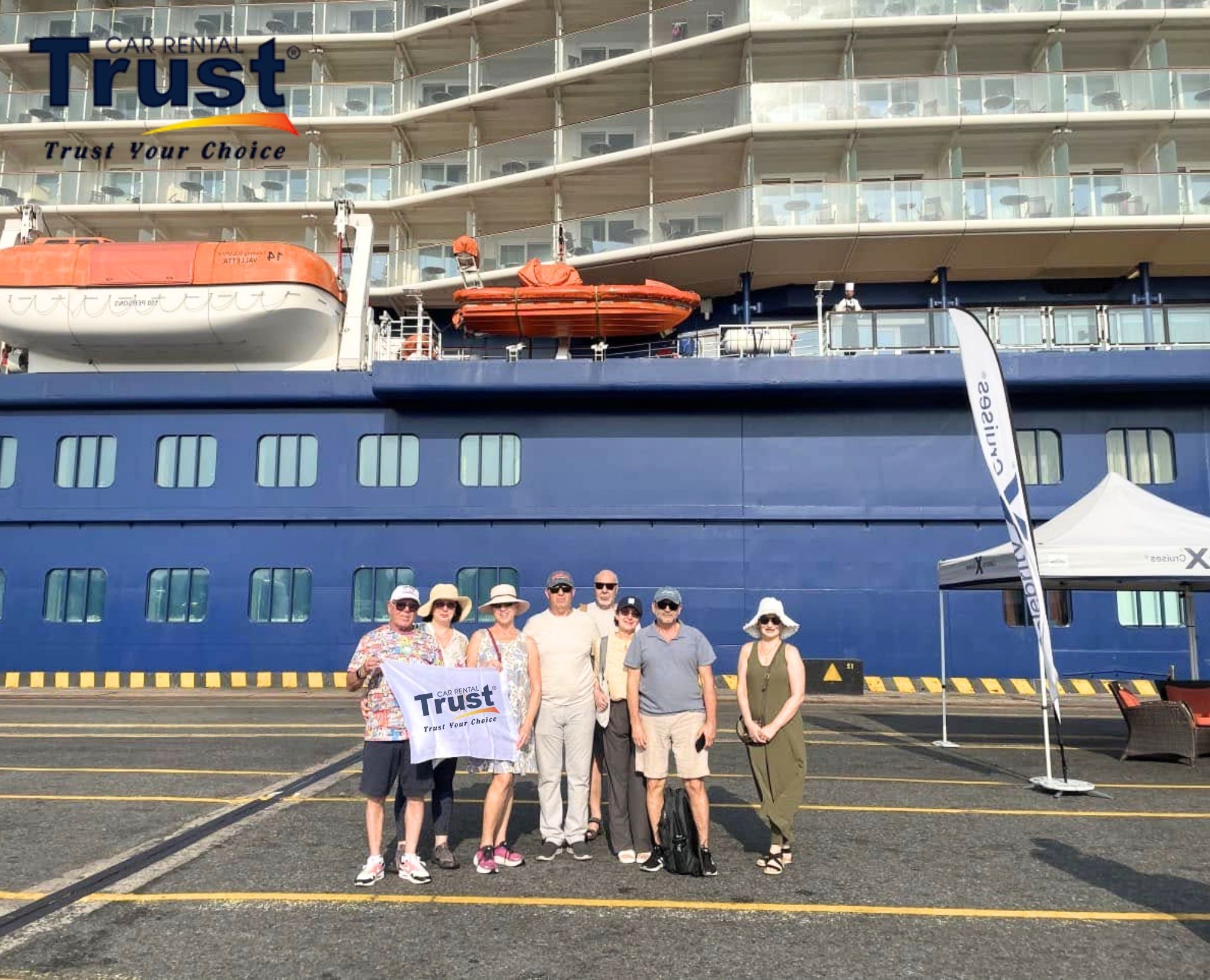 a-group-of-travelers-with-a-vietnam-trust-car-rental-banner-arranging-their-private-car-from-halong-port-to-hanoi