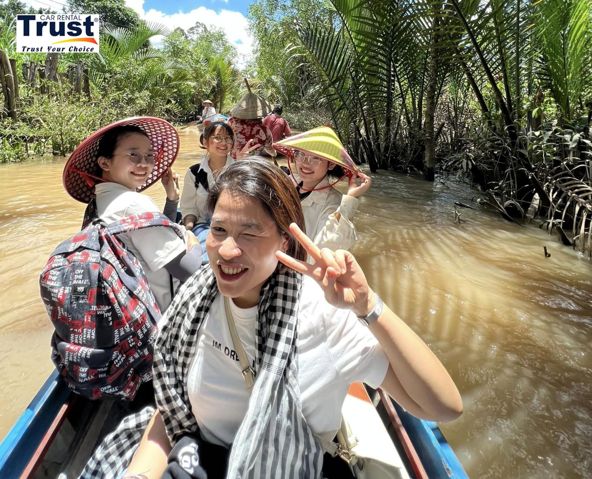 a-scenic-hand-rowing-sampan-ride-through-the-narrow-tree-lined-canals-of-my-tho-a-typical-mekong-delta-experience