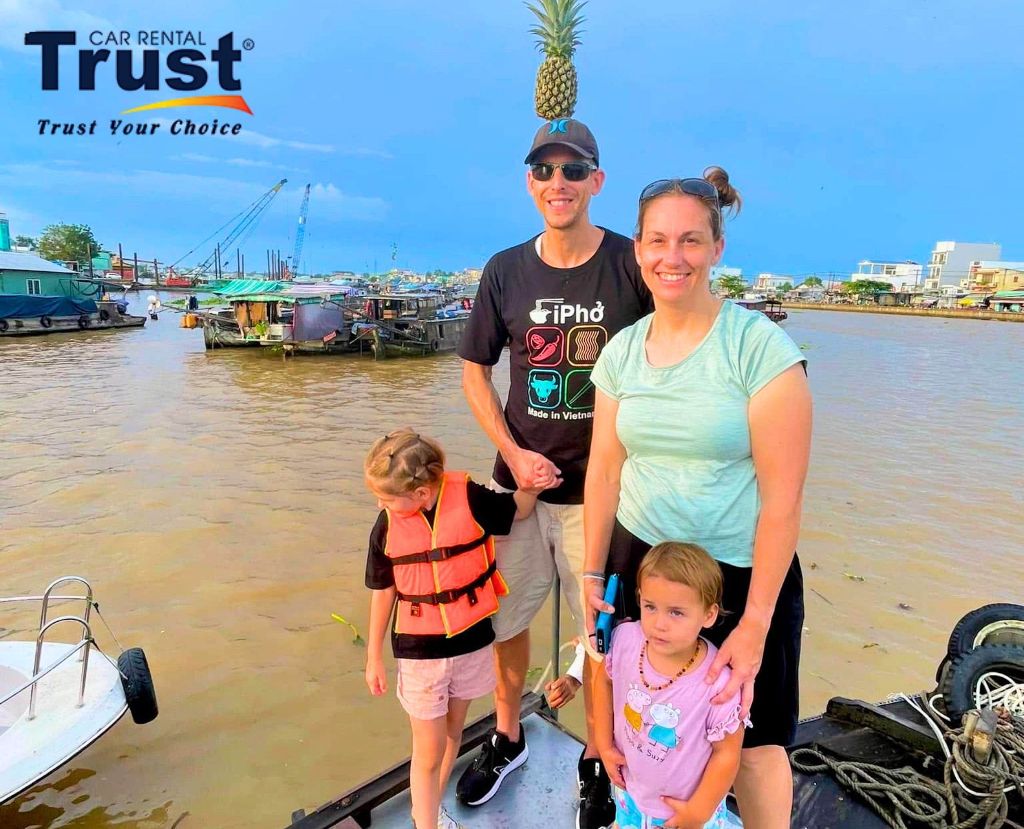 A small family visits Cai Rang Floating Market, observing the daily life of the local people