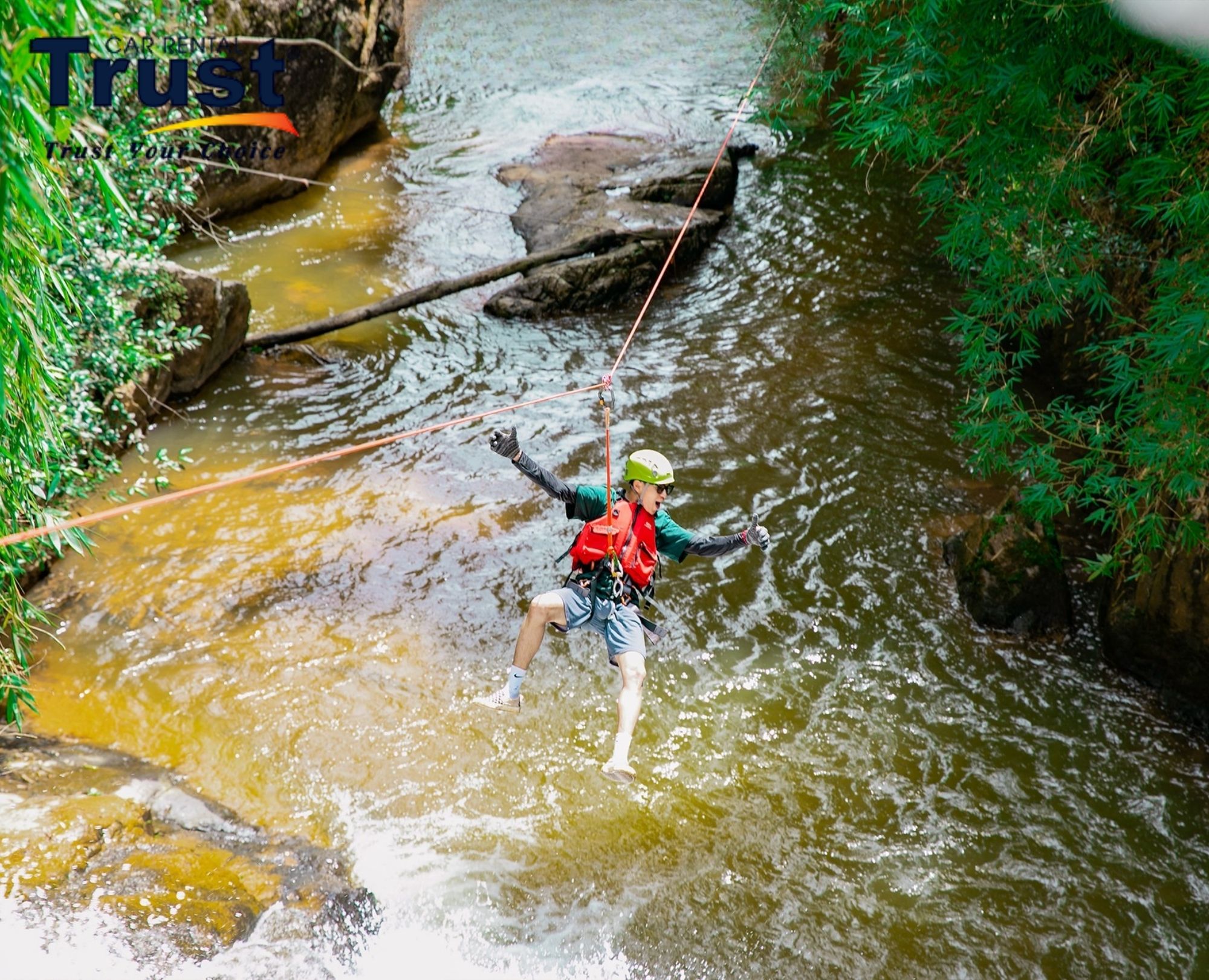 A tourist enjoying the High Rope Course at Datanla Waterfall during a Dalat Waterfall tour