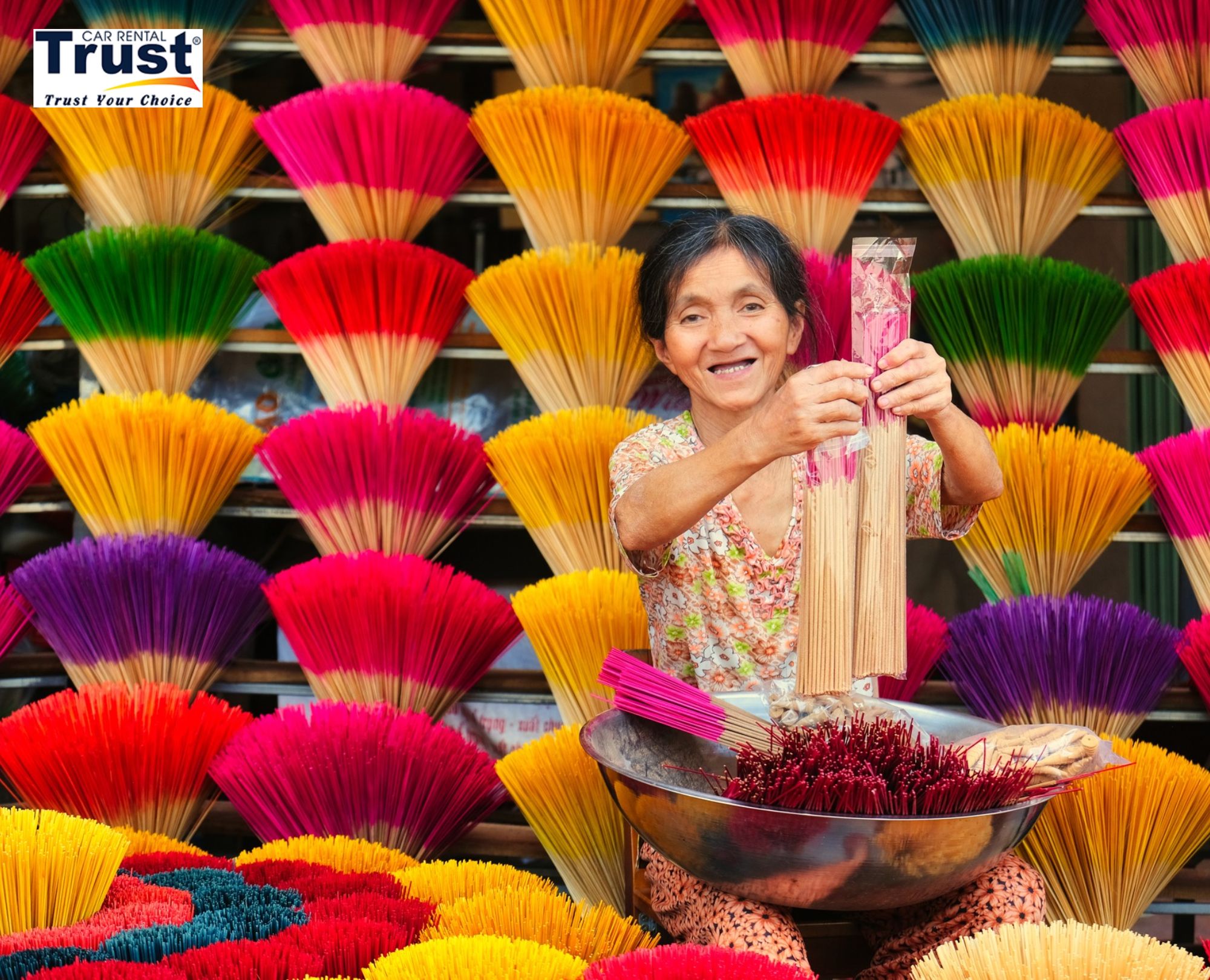 artisan-in-thuy-xuan-incense-village-proudly-holding-incense-bundles-amidst-a-colorful-backdrop-of-handmade-sticks