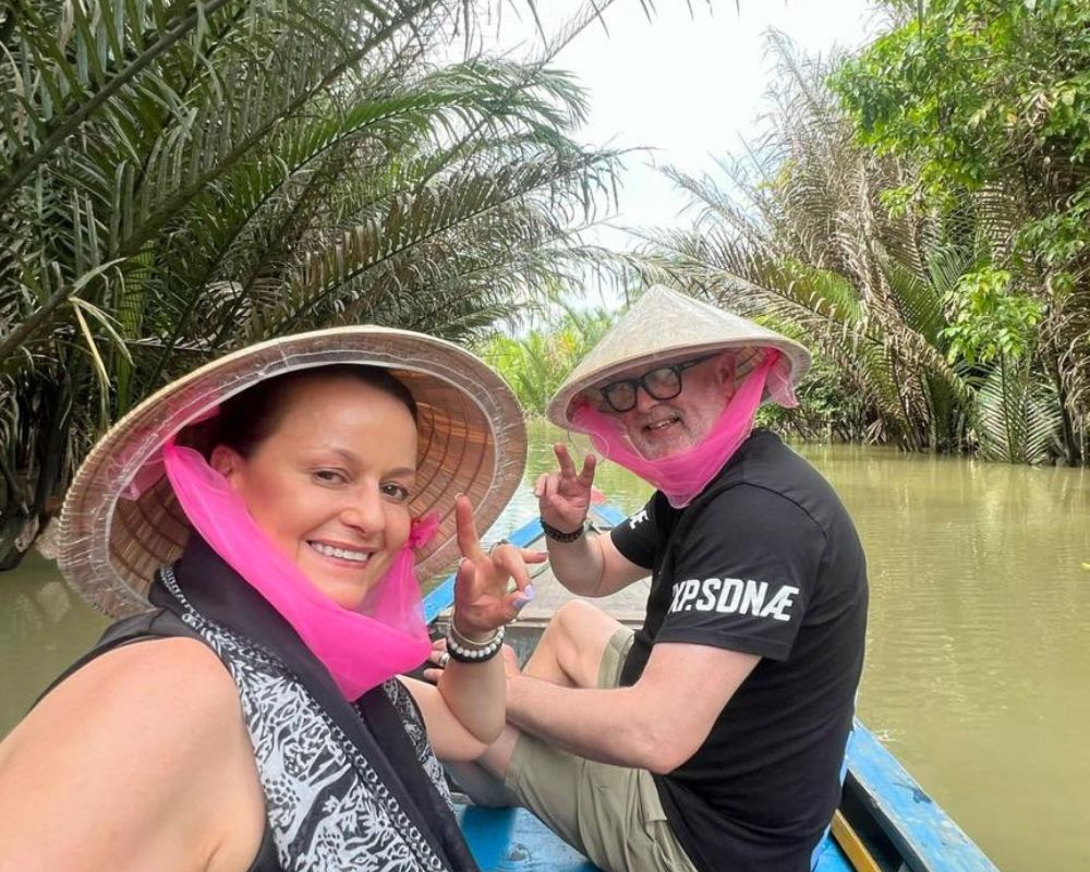 Board a motorized boat on the Tien River