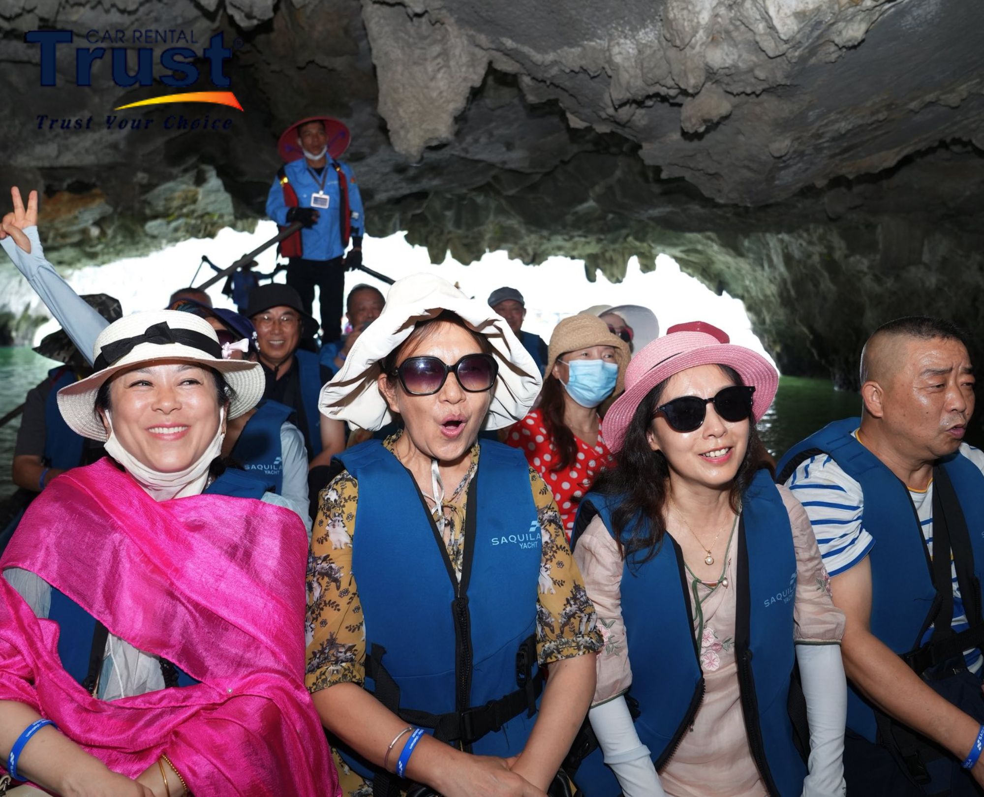 Excited tourists on a small boat inside Luon Cave tunnel on a popular Halong Bay 1 day cruise excursion