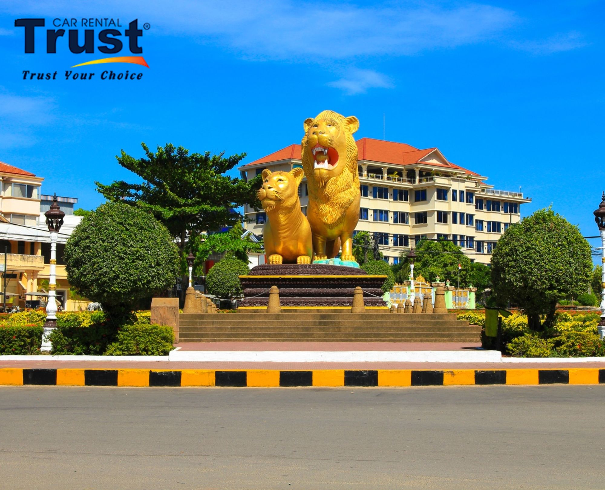 Golden Lions Roundabout Sihanoukville with large golden lion sculptures and greenery