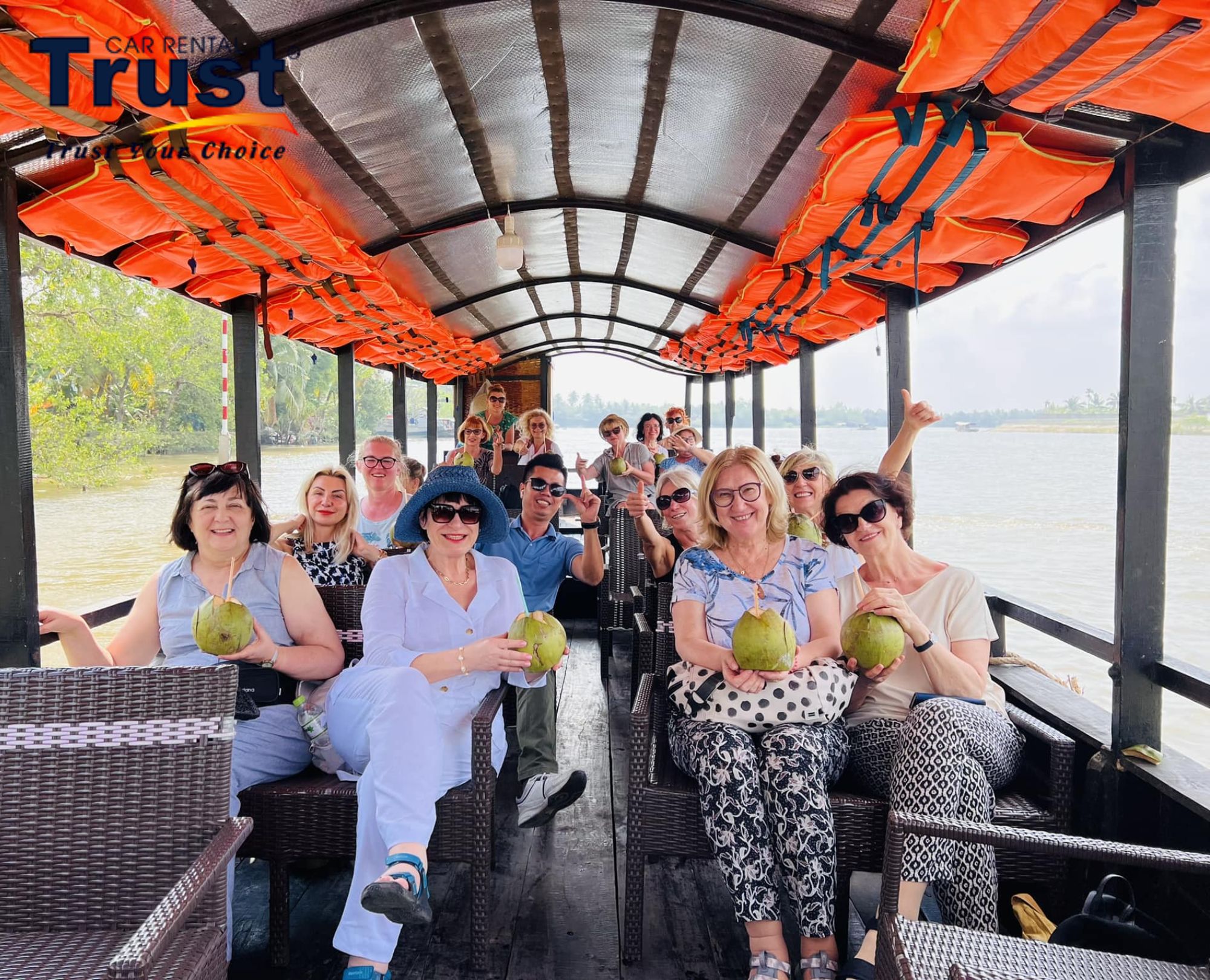 Group enjoying a boat trip as part of a Mekong Delta tour