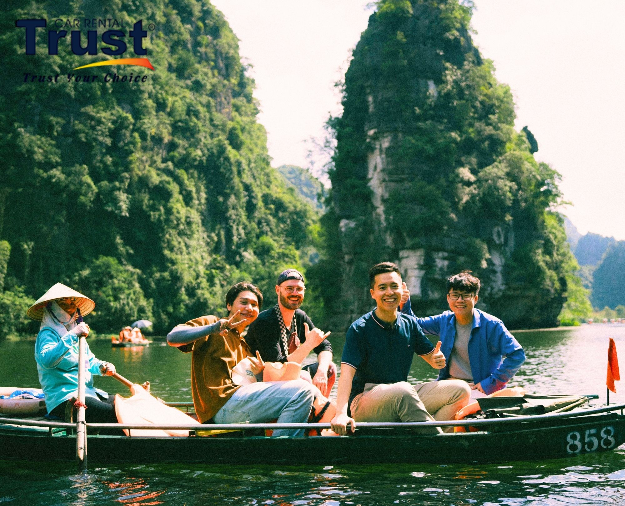happy-tourists-enjoying-a-boat-tour-in-ninh-binh-after-a-long-distance-transfer-via-taxi-hue-to-ninh-binh-service