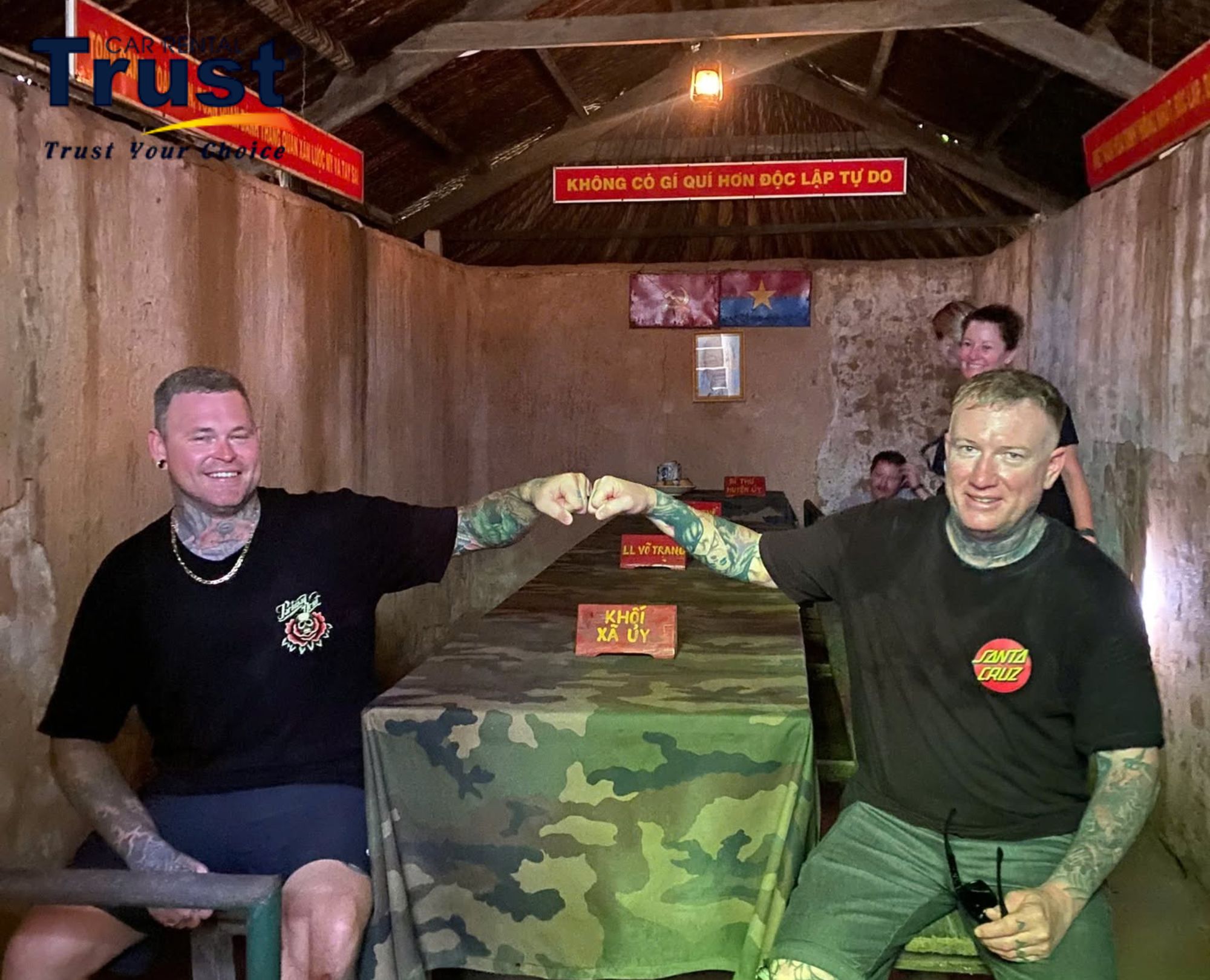 International visitors exploring war history and taking photos inside the Cu Chi Tunnels briefing room