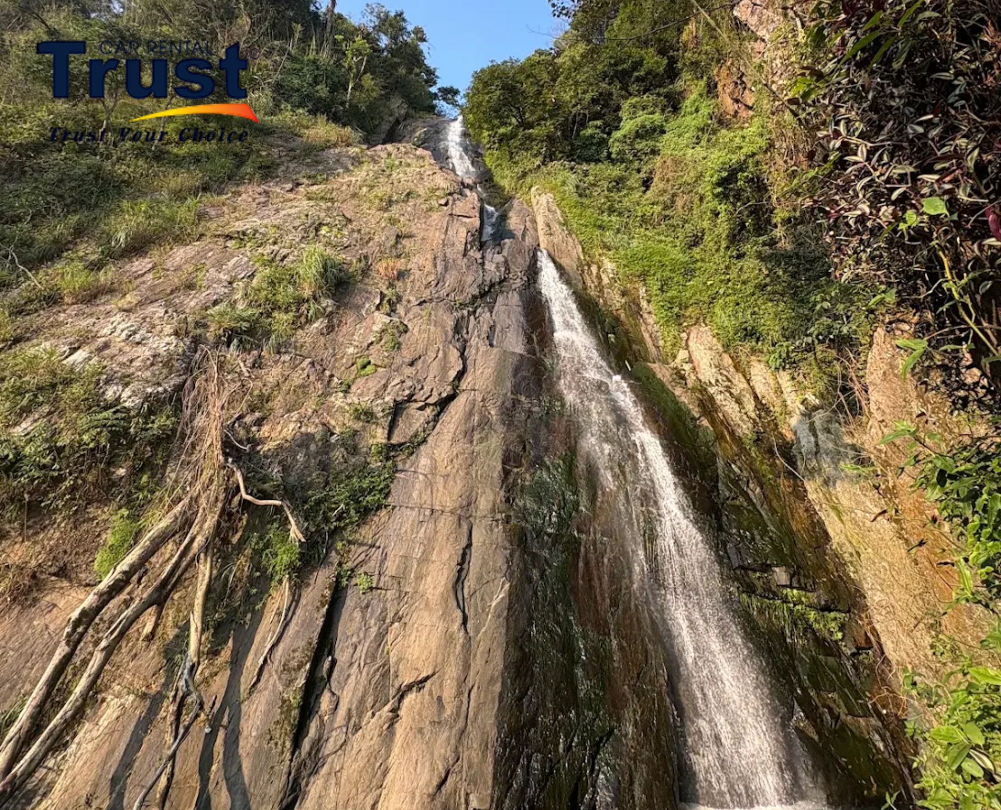 Scenic view of Silver Waterfall surrounded by lush green mountains in Tam Dao