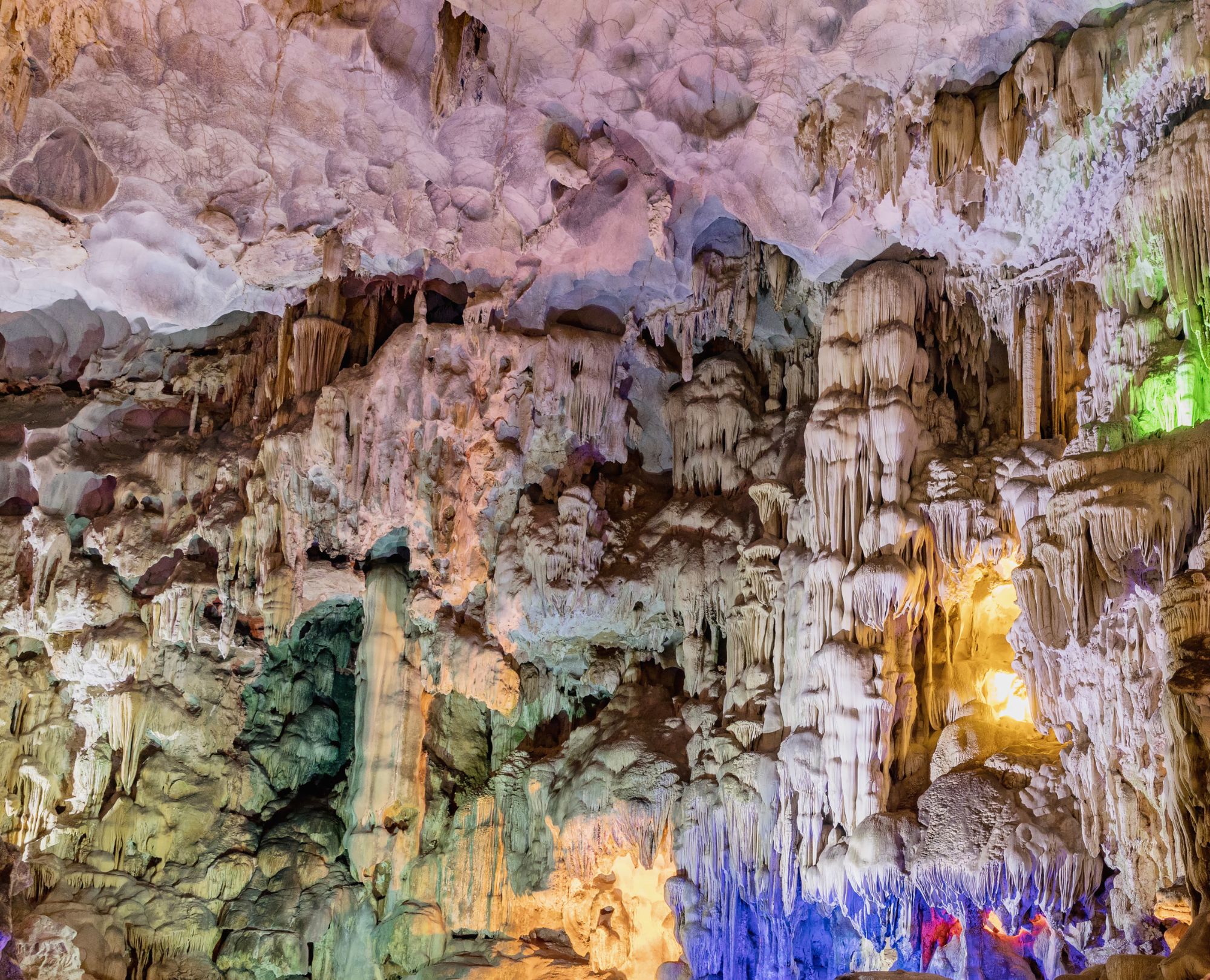 Stunning rock formations and colorful lighting inside Sung Sot Cave, a must-visit destination on a Halong Bay cruise tour