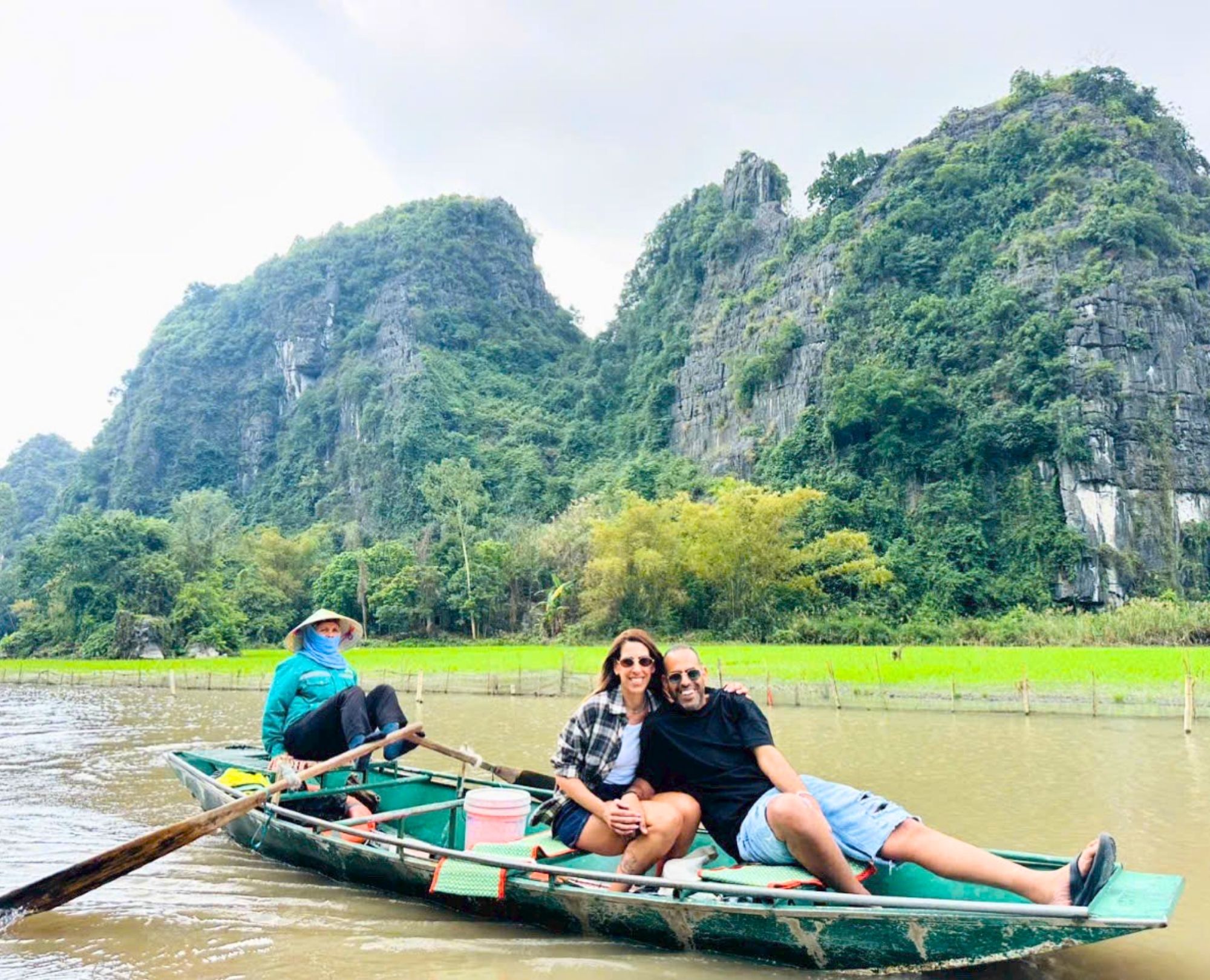 Tourists enjoying a scenic boat trip in Trang An Ninh Binh with a local rower