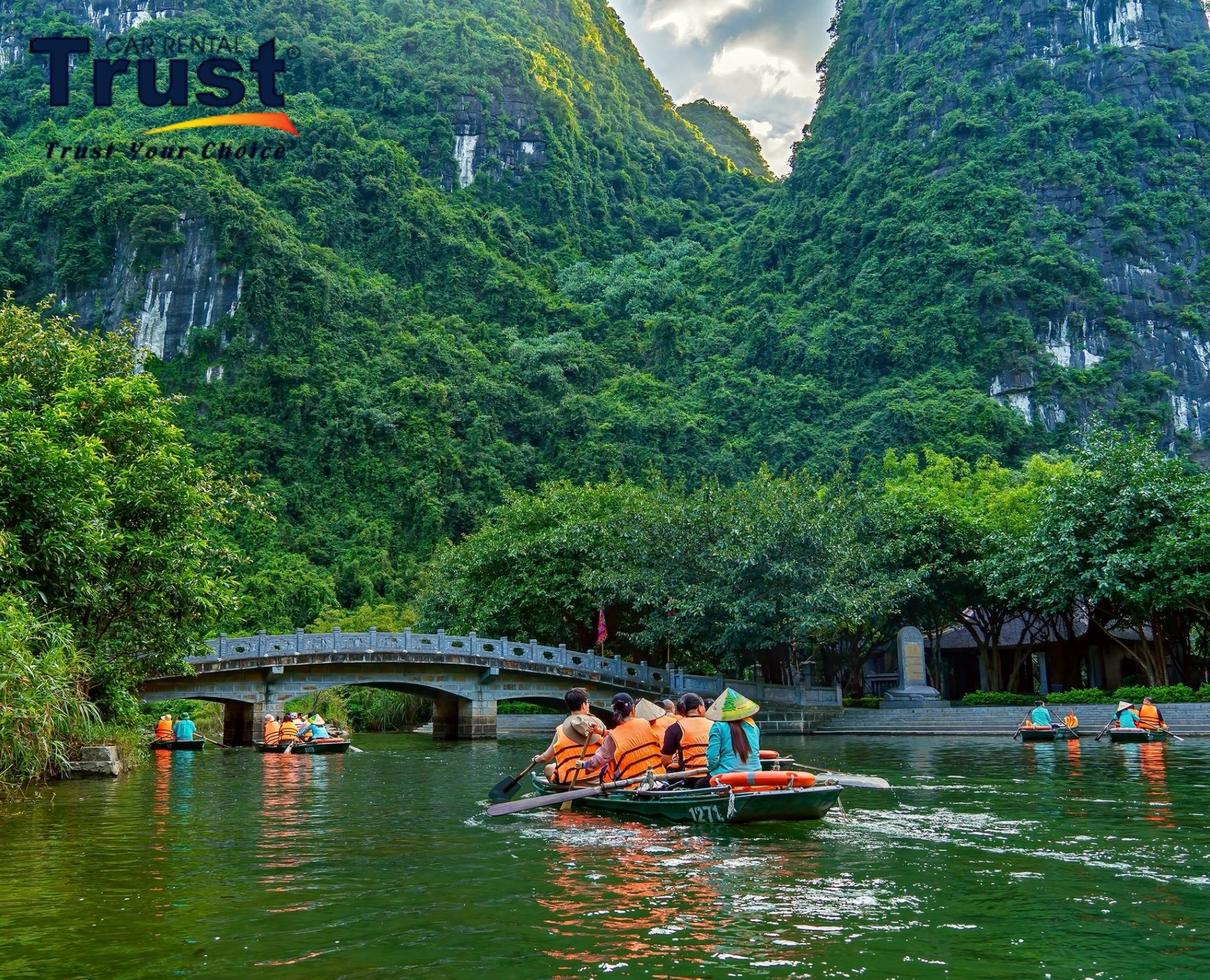 tourists-enjoying-a-traditional-boat-ride-through-the-stunning-limestone-karsts-and-lush-greenery-of-tam-coc