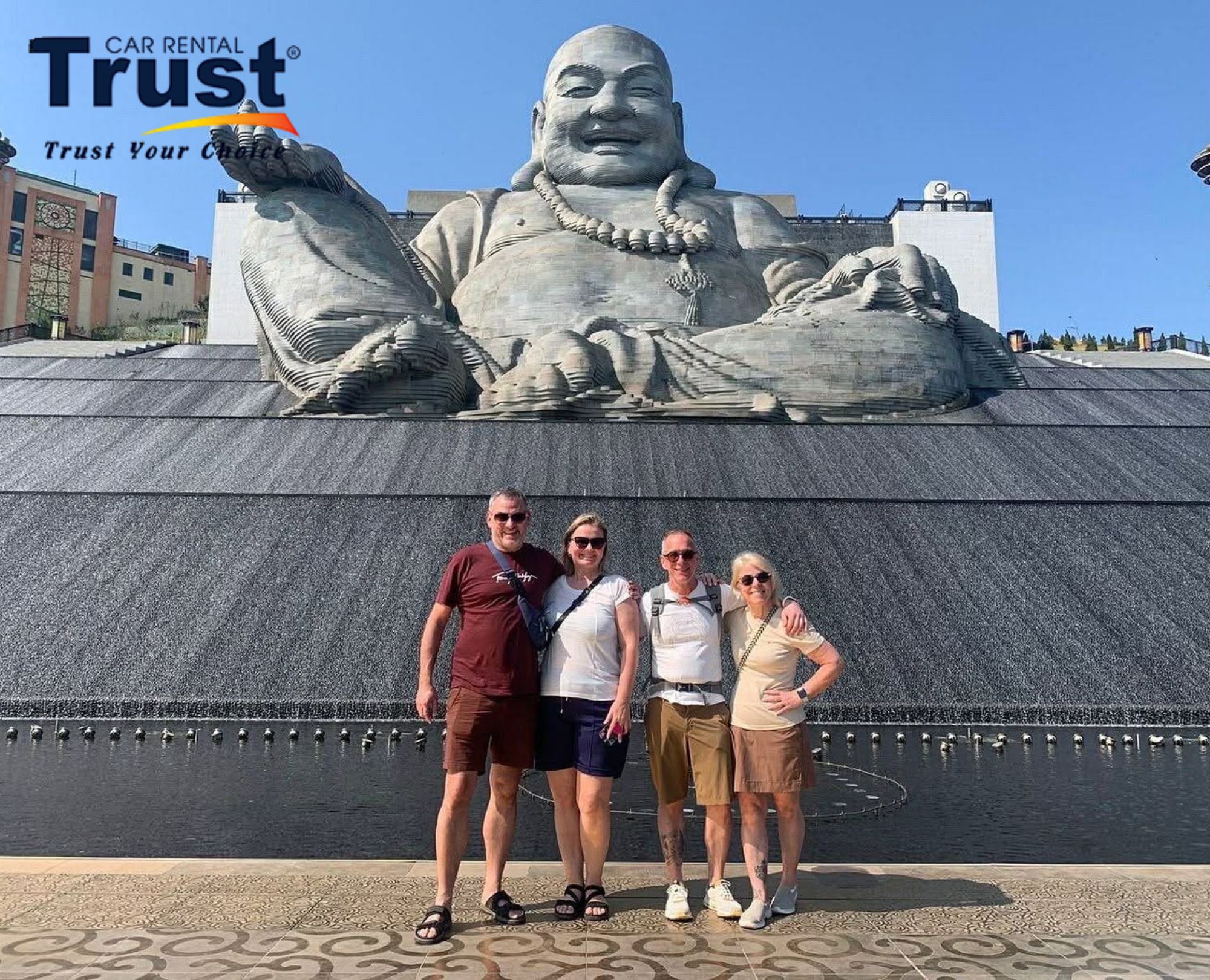 Tourists taking photos in front of a Maitreya statue at Black Virgin Mountain