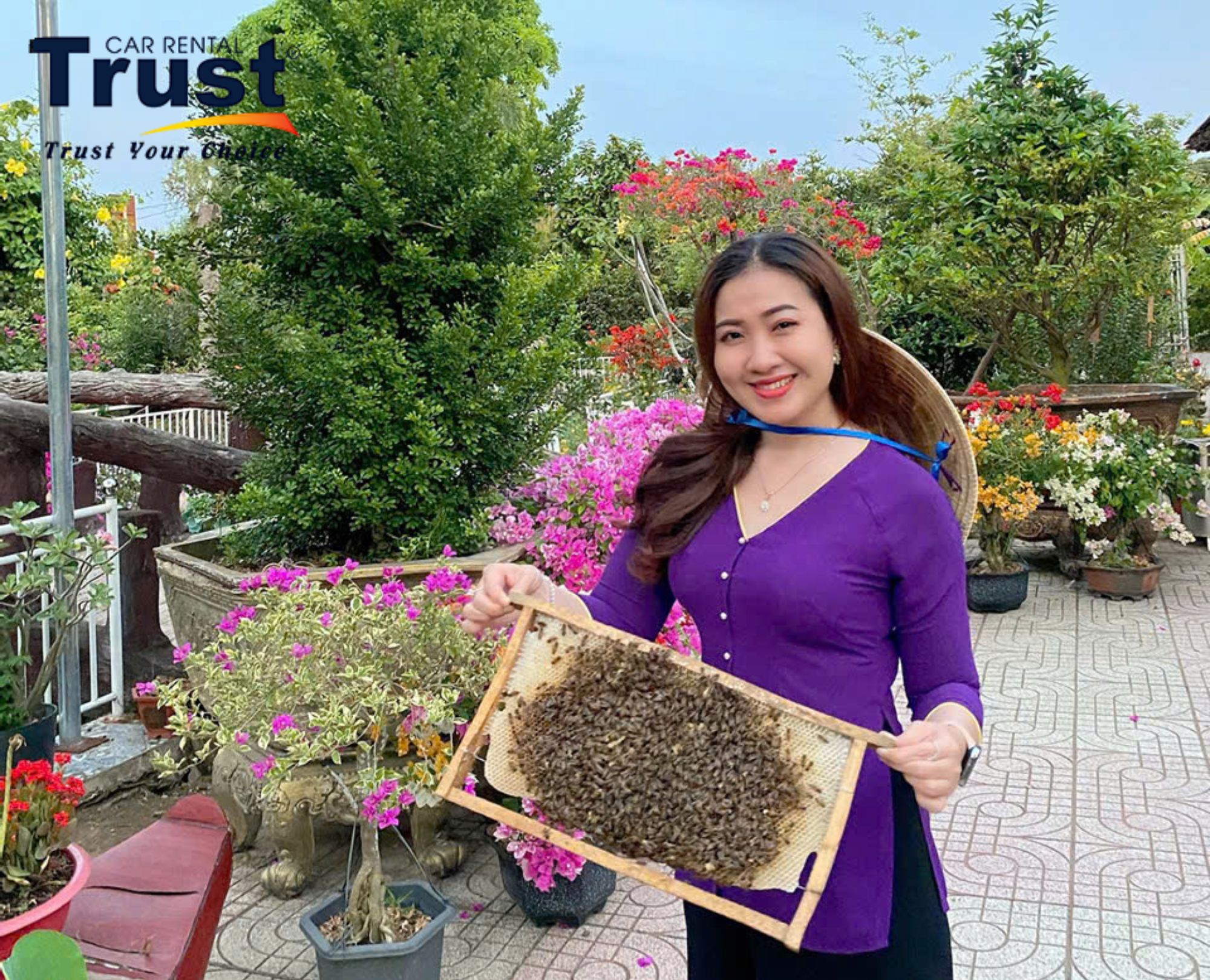 Woman holding a honeycomb frame with bees, enjoying honey in the Mekong Delta